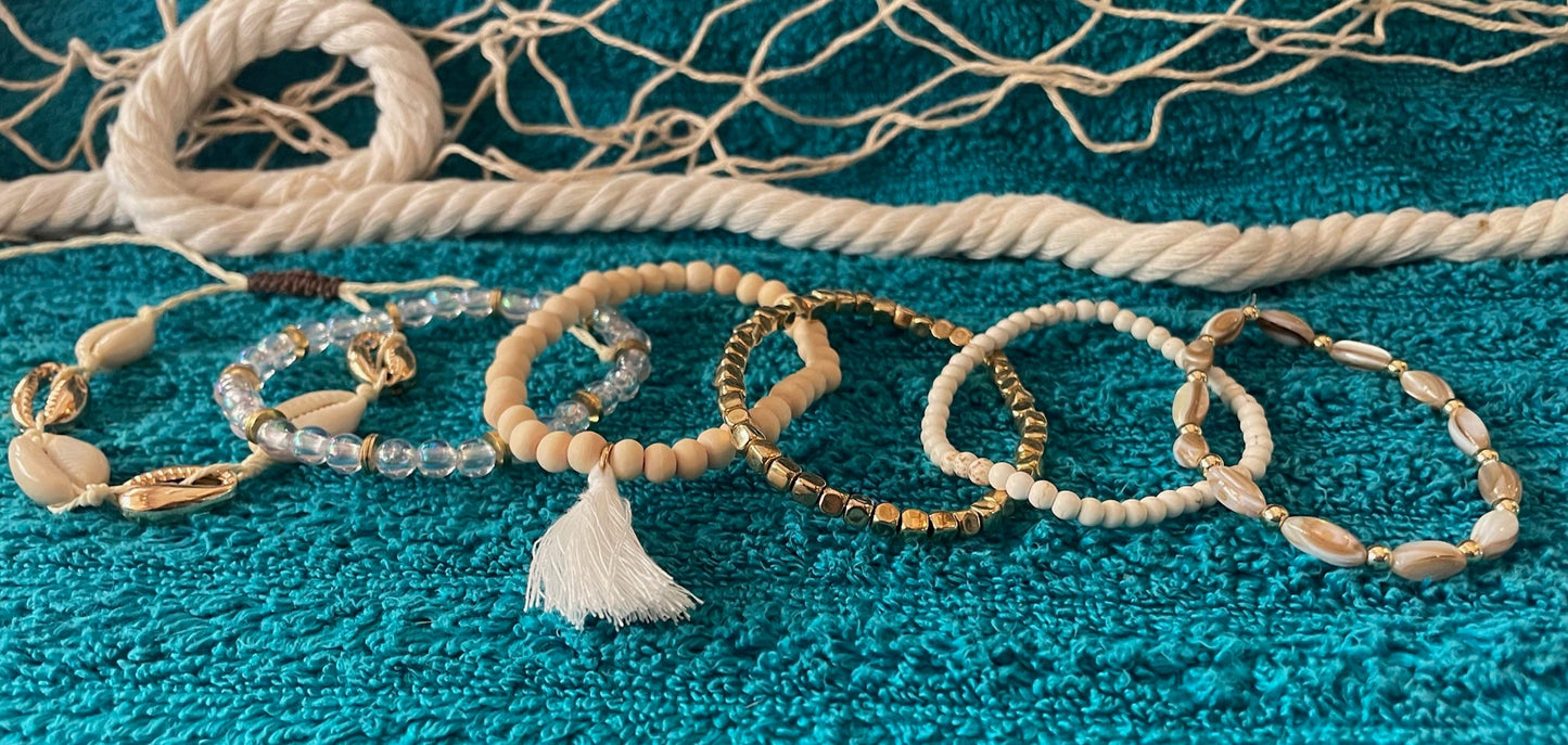 Set of beaded bracelets on a textured blue surface with a fishing net in the background